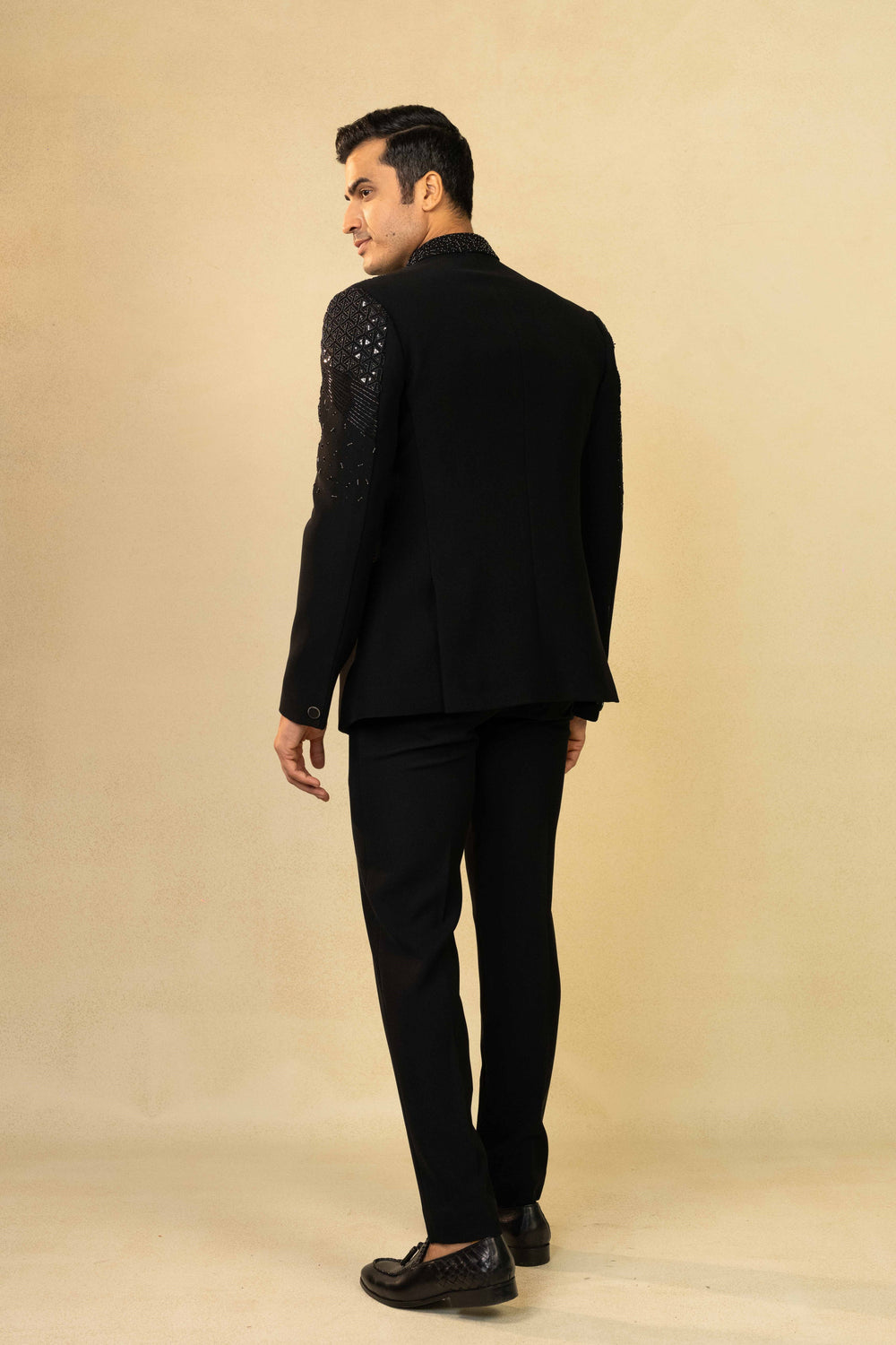 Black Jodhpuri suit featuring refined pin-tuck detailing and metallic embroidery