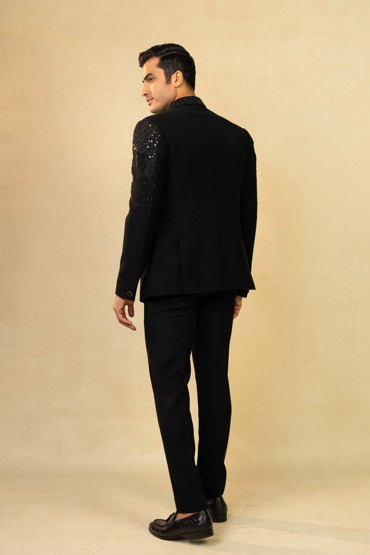 Black Jodhpuri suit featuring refined pin-tuck detailing and metallic embroidery