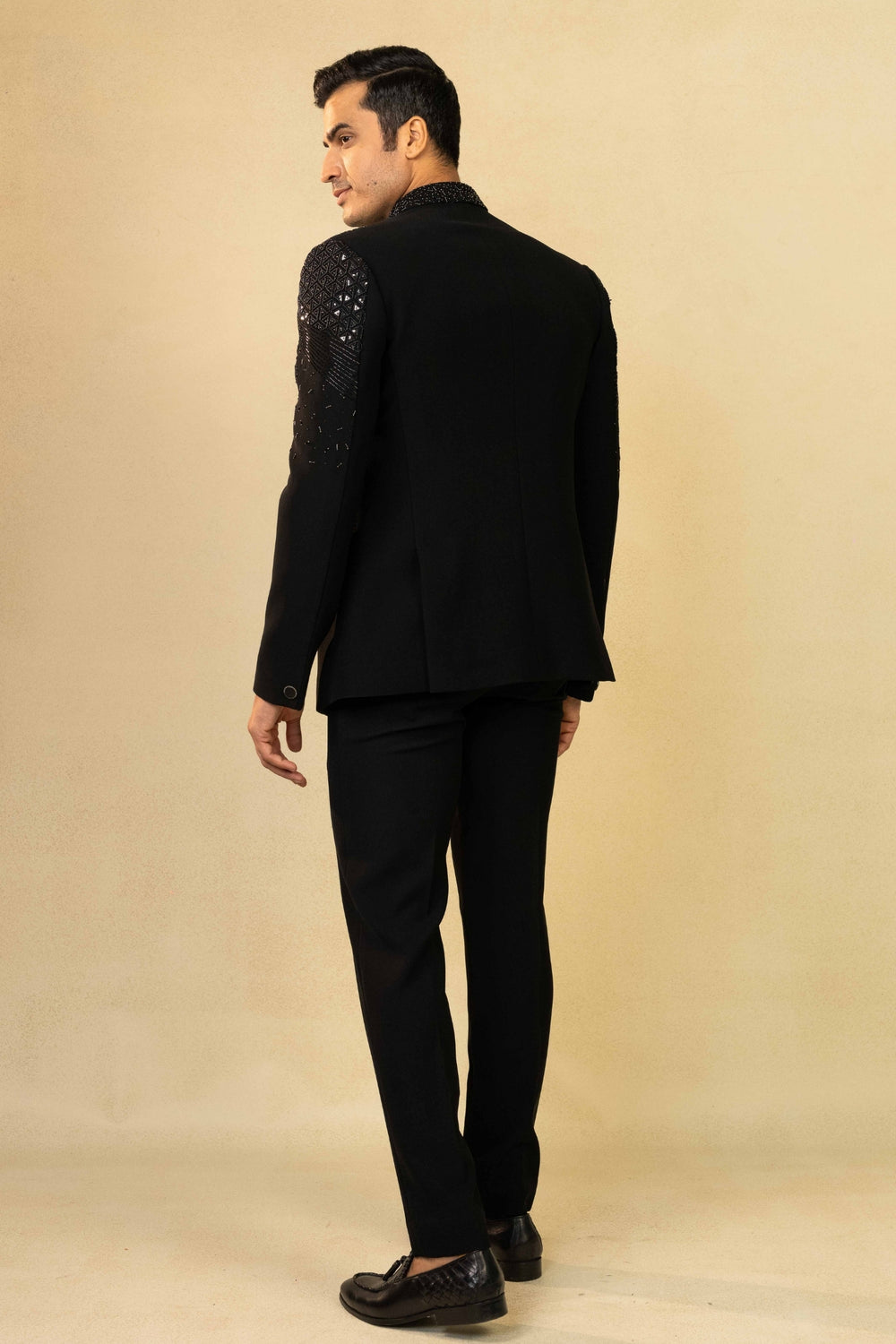 Black Jodhpuri suit featuring refined pin-tuck detailing and metallic embroidery