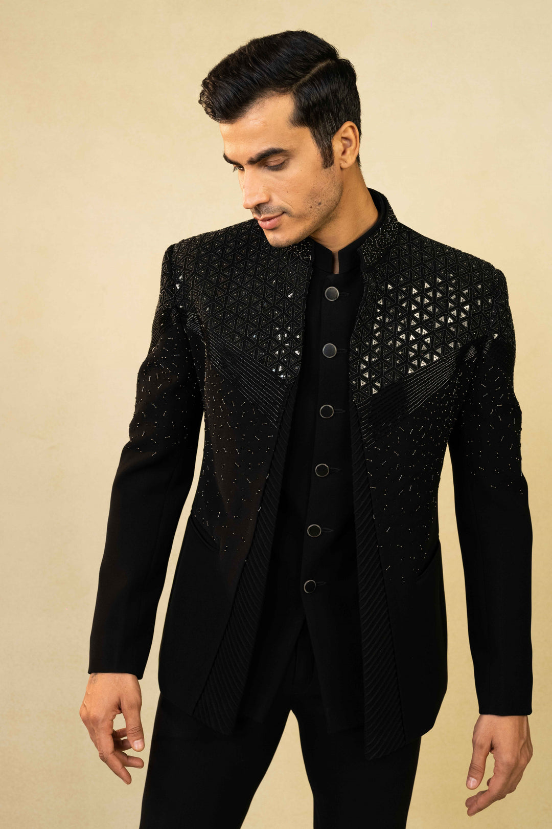 Black Jodhpuri suit featuring refined pin-tuck detailing and metallic embroidery
