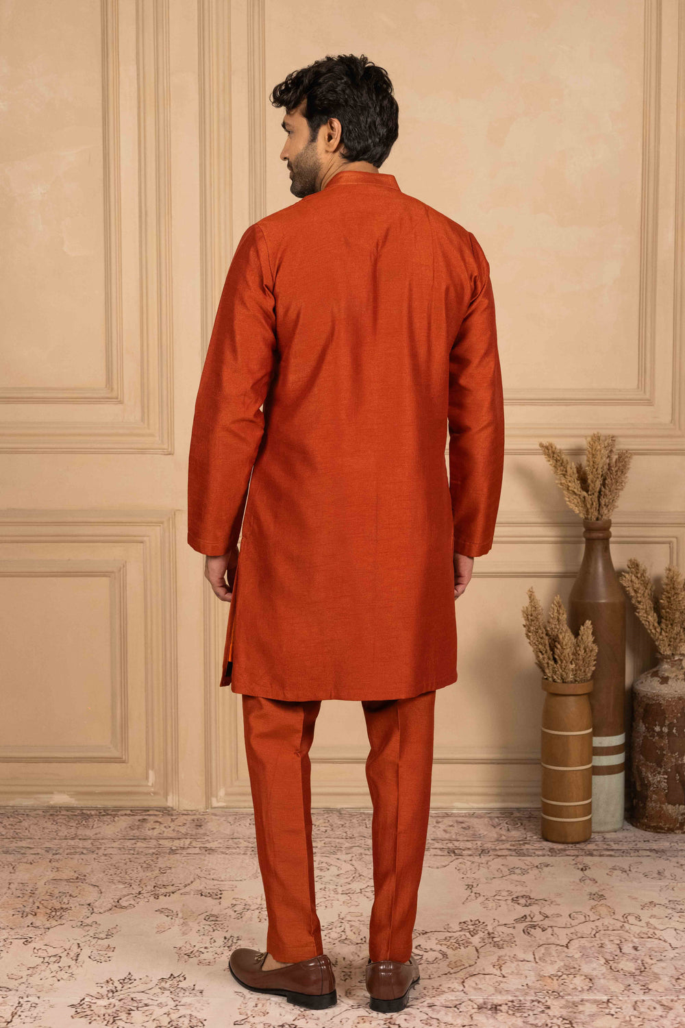 Burnt orange kurta adorned with Reshamkari embroidery
