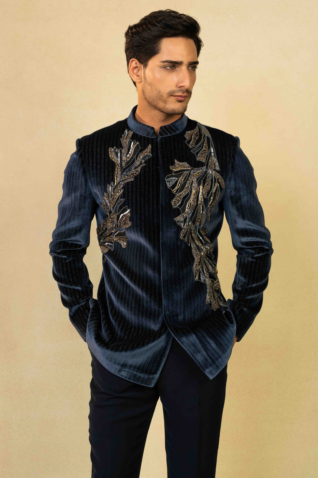 Midnight blue Jodhpuri suit adorned with intricate hand embroidery.