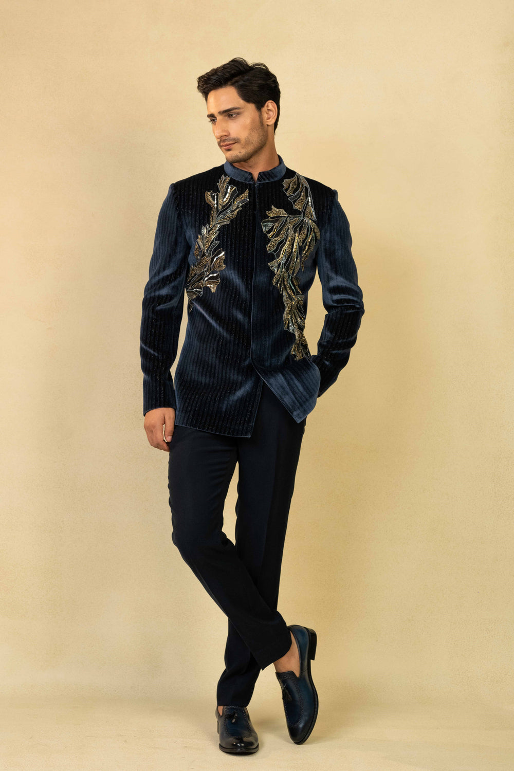 Midnight blue Jodhpuri suit adorned with intricate hand embroidery.