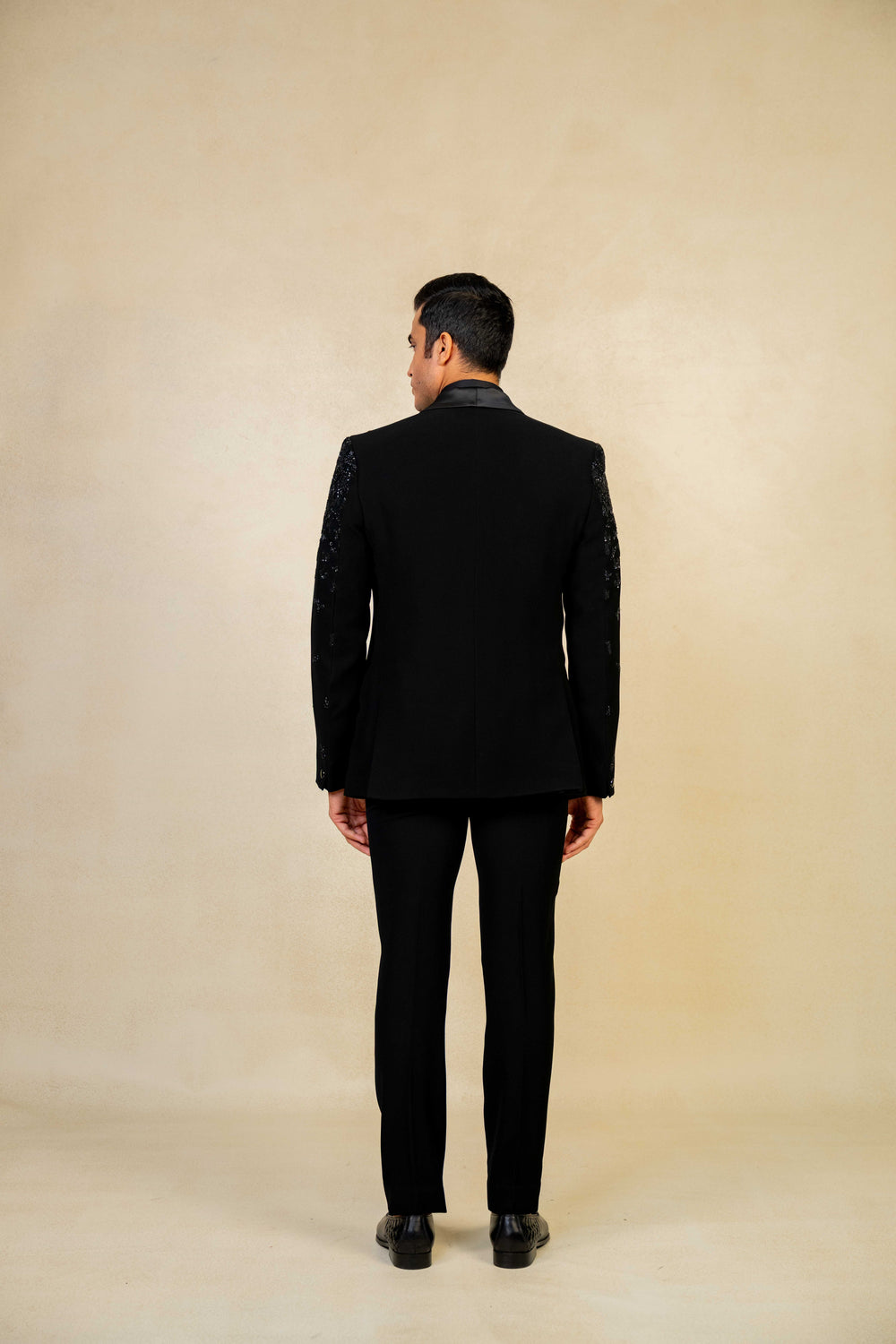 a blacktuxedo with abstract geometric embroidery